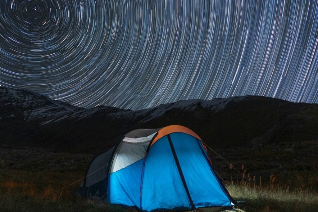Camping tent under star trails in the mountains