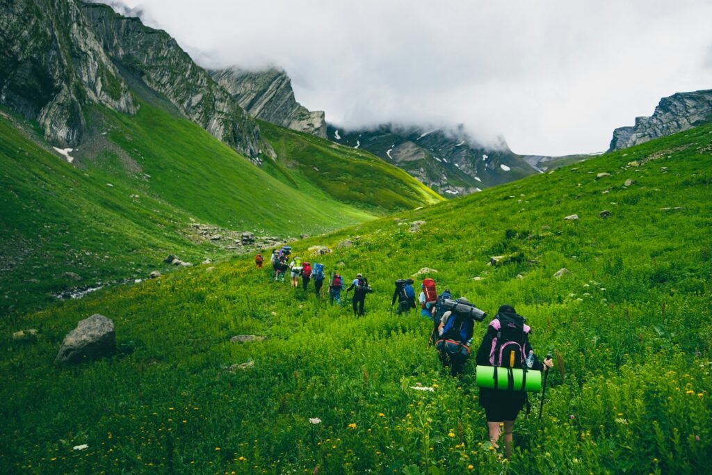 Group trekking tour through a green valley