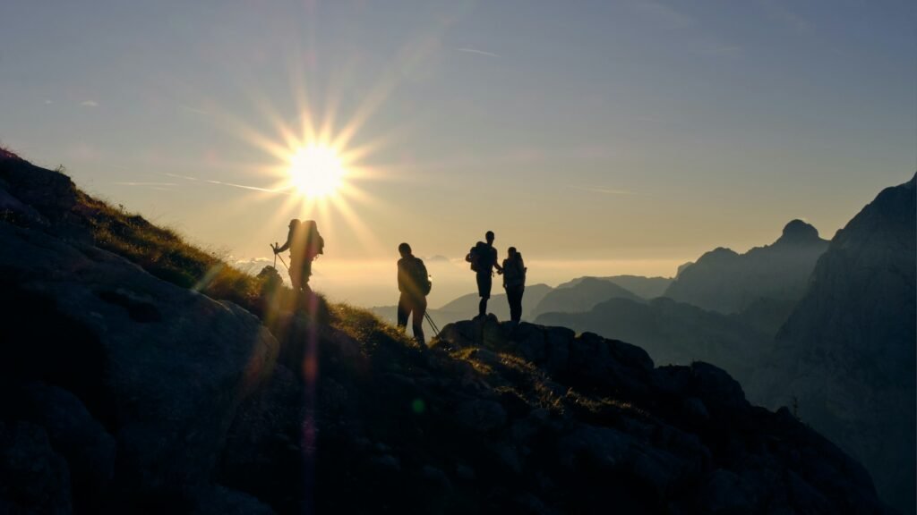 Hikers on a summit at sunset